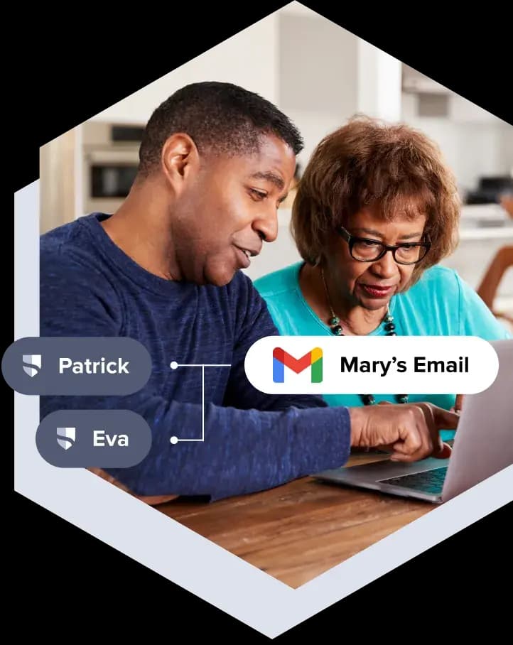 A son pointing something out on a laptop to his elderly mother. There are graphics on top depicting her gmail account connected to her 2 her children to monitor her account.